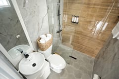 Second bathroom with warm wood-tile shower