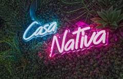 Casa Nativa neon sign on a living wall of greenery